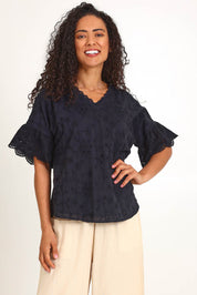 Model Pamelar wearing size 10 of the Essentials Broderie Frill Sleeve Cotton Top - Black in colour Black, in a cropped view