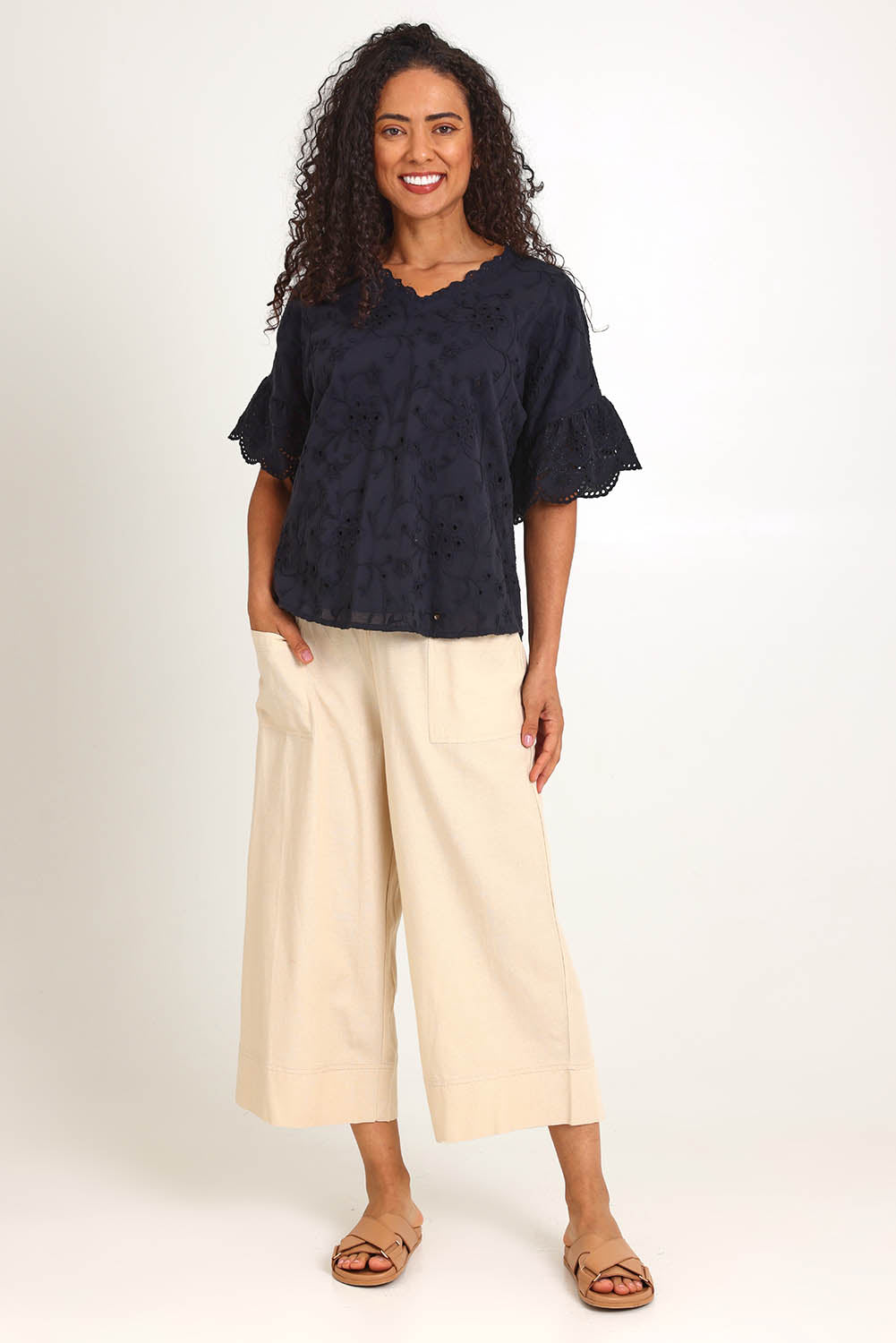Model Pamelar wearing size 10 of the Essentials Broderie Frill Sleeve Cotton Top - Black in colour Black, from the front