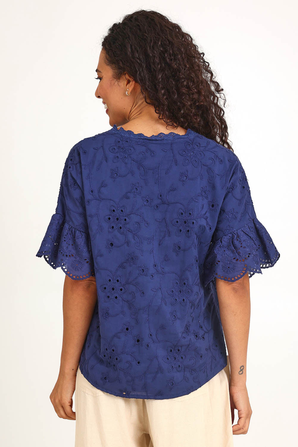 Model Pamelar wearing size 10 of the Essentials Broderie Frill Sleeve Cotton Top - Navy in colour Navy, from the back