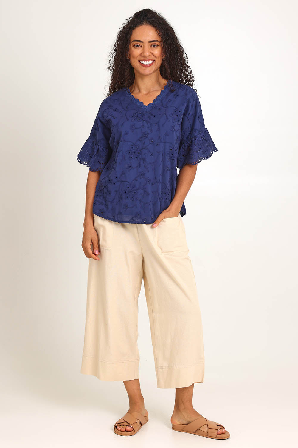 Model Pamelar wearing size 10 of the Essentials Broderie Frill Sleeve Cotton Top - Navy in colour Navy, from the front