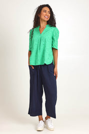 Model Pamelar wearing size 10 of the Essentials Broderie Cotton Top - Green in colour Green, from the front