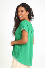 Model Pamelar wearing size 10 of the Embellished Tee – Green in colour Green, from an angle