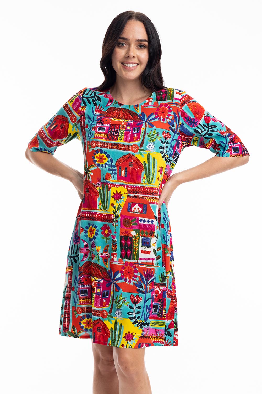 A model wearing the Contemporary Elbow Sleeve Dress in colour Folkhuts (Blue), from the front, cropped image