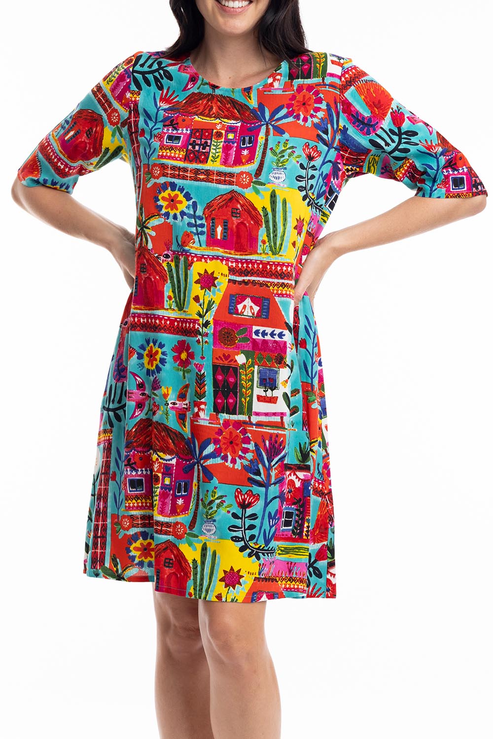A model wearing the Contemporary Elbow Sleeve Dress in colour Folkhuts (Blue), from the front, cropped image