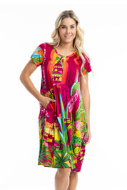 A model wearing the Printed Bubble Organic Cotton Dress in colour Marrakesh (Red), from the front, cropped image