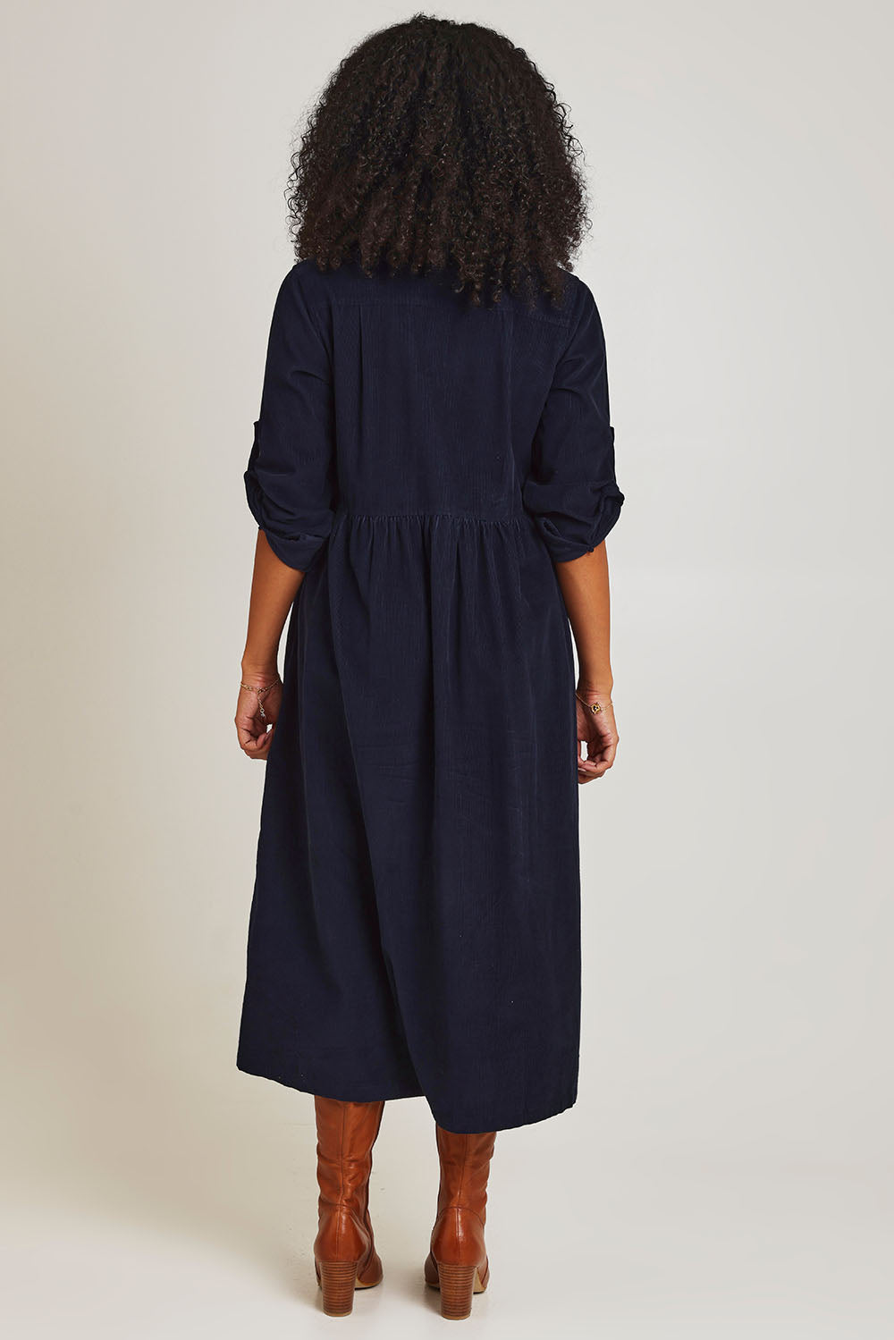 Model Ziara wearing size 10 of the Corduroy Collar Dress in colour Navy (Blue), from the back