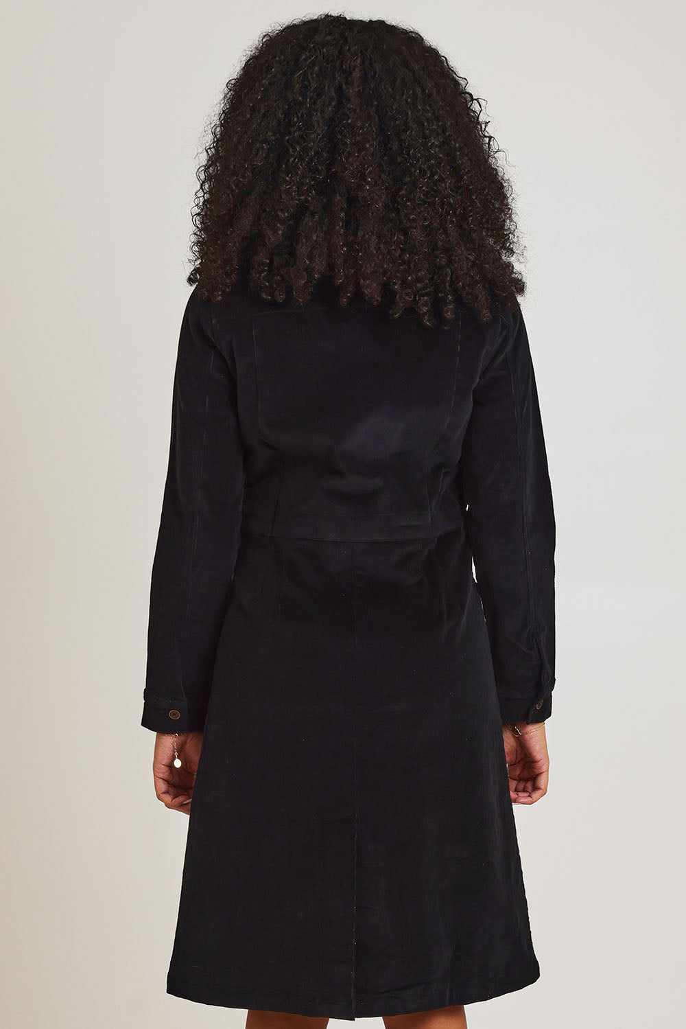 Model Ziara wearing size 10 of the Cotton Corduroy Button Dress in colour Black (Black), from the back