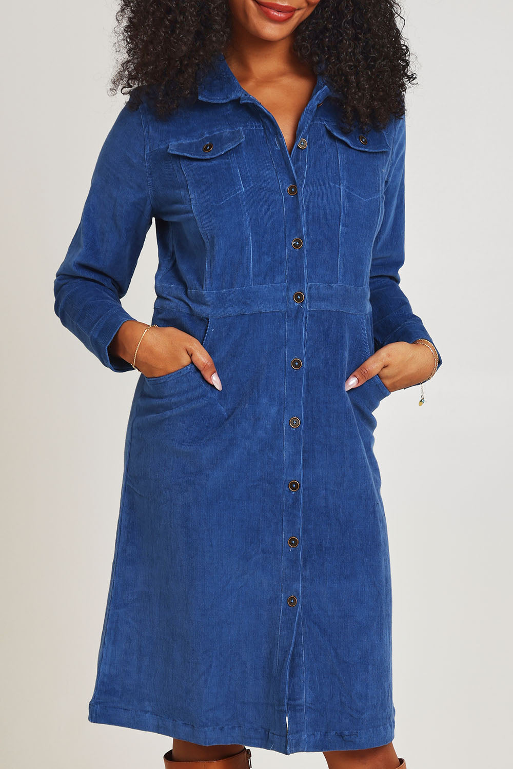 Model Ziara wearing size 10 of the Cotton Corduroy Button Dress in colour Blue (Blue), from the front, cropped image