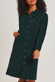 Model Ziara wearing size 10 of the Cotton Corduroy Button Dress in colour Pine (Green), from the front, cropped image