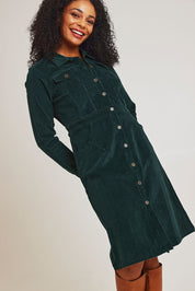 Model Ziara wearing size 10 of the Cotton Corduroy Button Dress in colour Pine (Green), from the front, cropped image