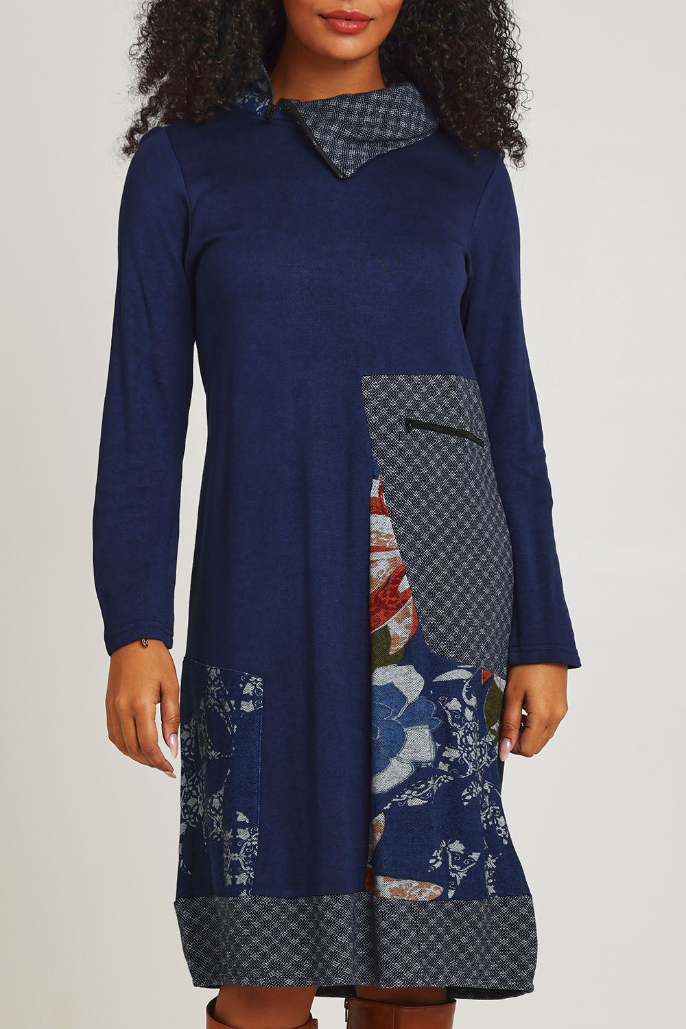 Model Ziara wearing size 10 of the Dancing Queen Cotton Patch Dress in colour Dancing (Blue), from the front, cropped image
