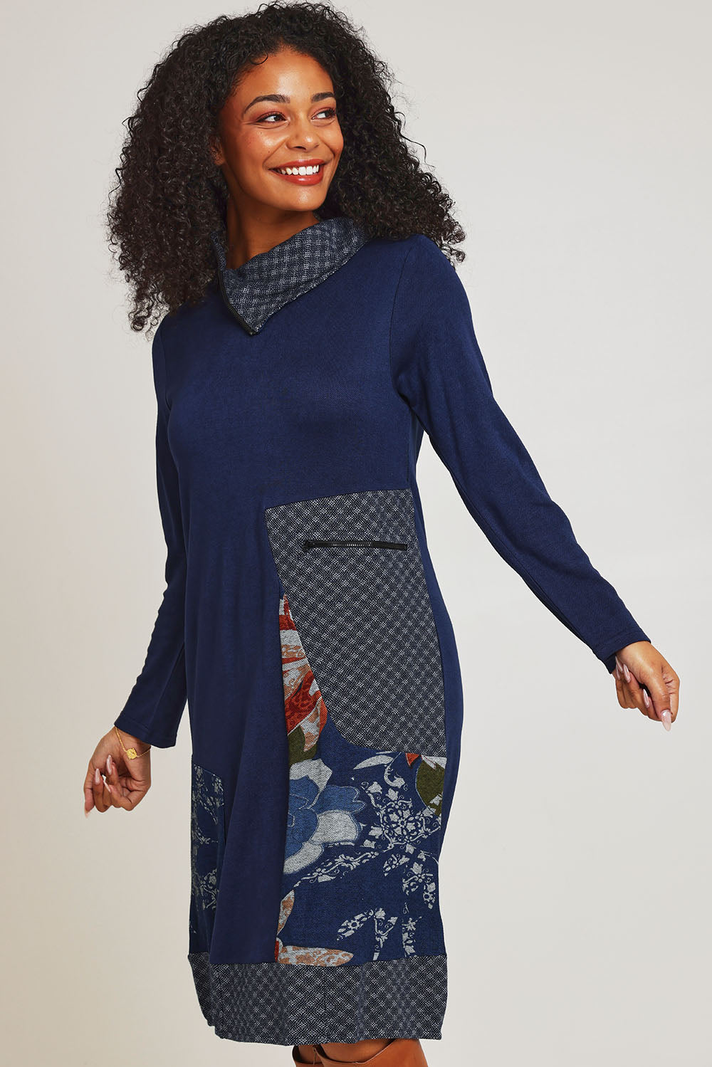 Model Ziara wearing size 10 of the Dancing Queen Cotton Patch Dress in colour Dancing (Blue), from the front, cropped image