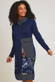 Model Ziara wearing size 10 of the Dancing Queen Cotton Patch Dress in colour Dancing (Blue), from the front, cropped image