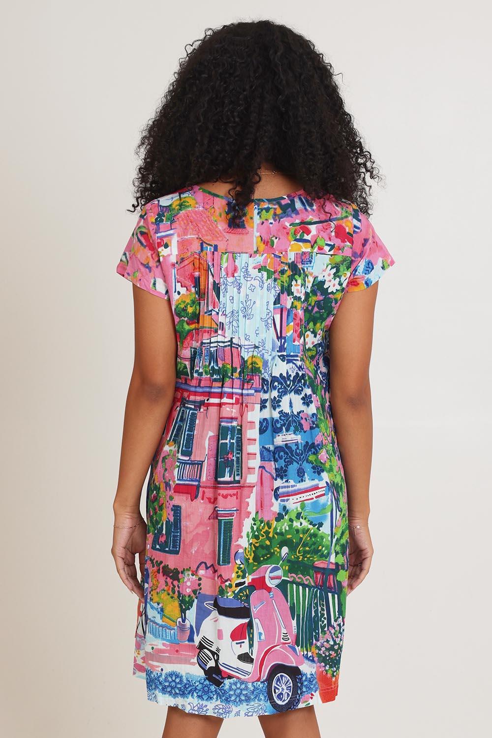Model Ziara wearing size 10 of the Ezy Fit Cotton Dress in colour Scooter (Pink), from the back
