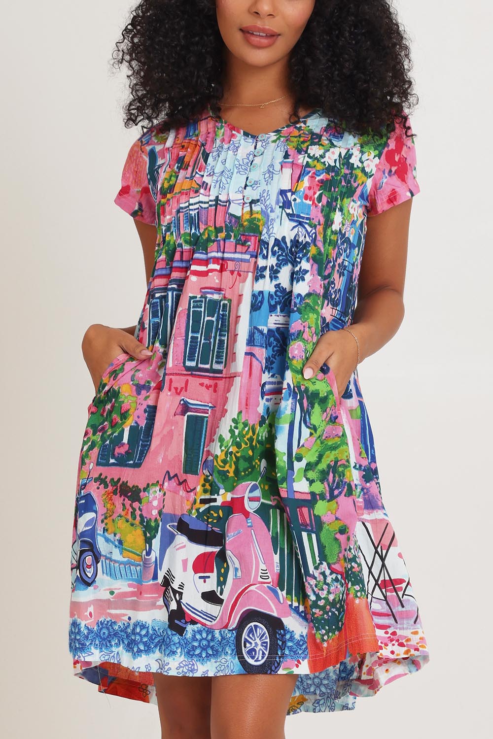 Model Ziara wearing size 10 of the Ezy Fit Cotton Dress in colour Scooter (Pink), from the front, cropped image