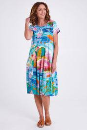 Model Emma wearing size 10 of the Printed Bubble Organic Cotton Dress in colour Dreamland (Blue), from the front, showing the whole outfit