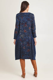 Model Madeline wearing size 10 of the Bubble Dress in colour Tabriz (Blue), from the back