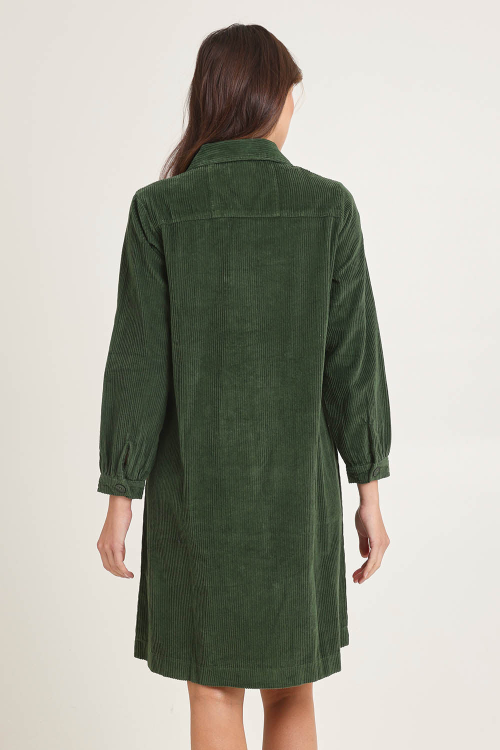 Model Madeline wearing size 10 of the Cord Solids Pockets Dress in colour Military (Green), from the back