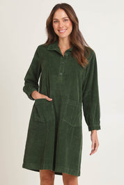 Model Madeline wearing size 10 of the Cord Solids Pockets Dress in colour Military (Green), from the front, cropped image