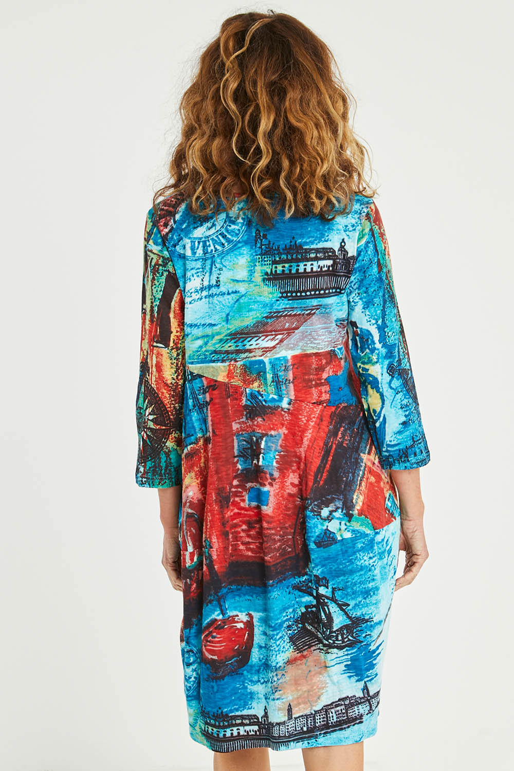 Model Emma wearing size 10 of the Cotton Bubble Dress in colour Venicemult (Blue), from the back