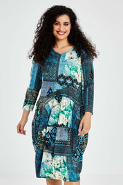 A model wearing size 10 of the Isfahani Dress Bubble in colour Blue (Blue), from the front, cropped image