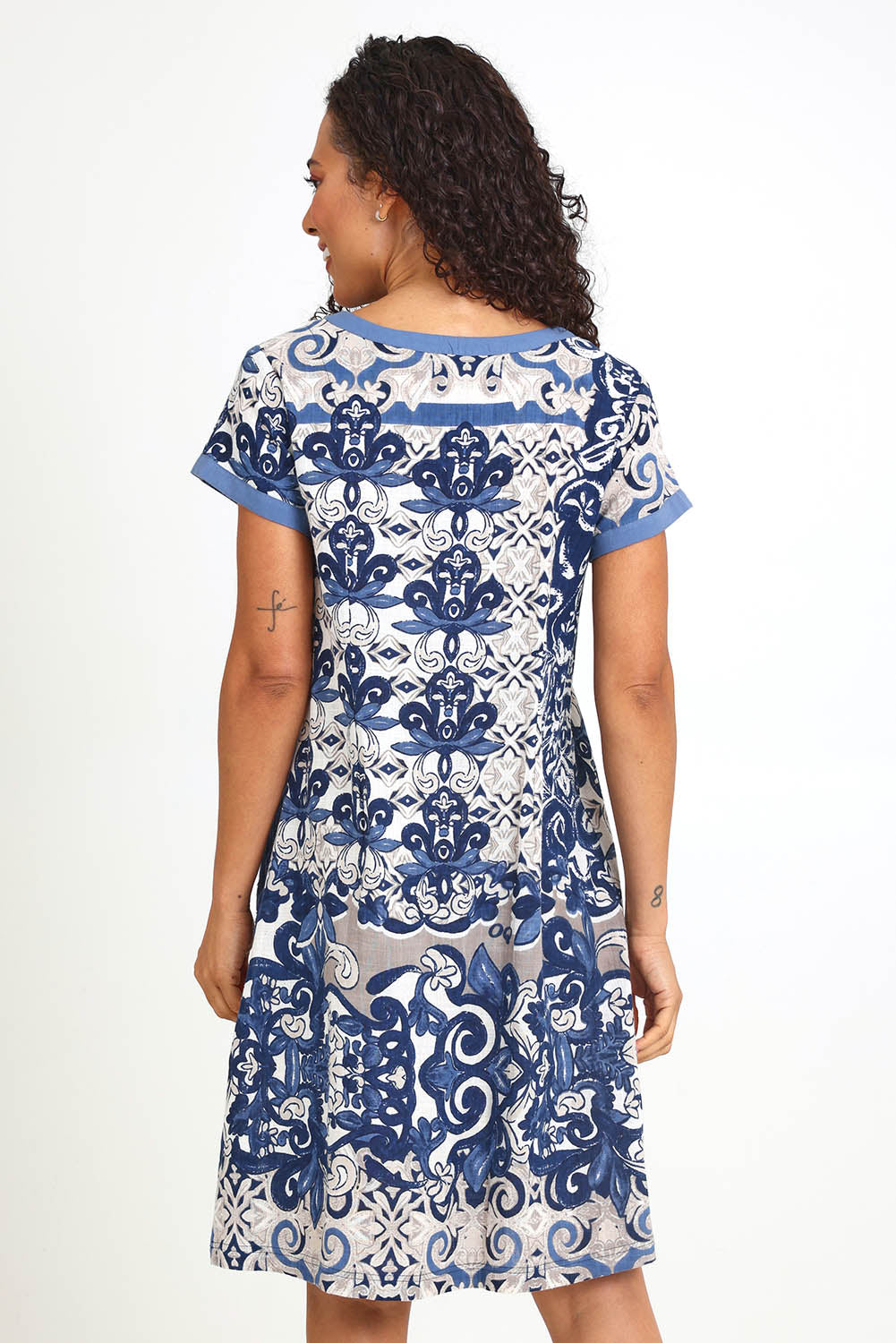 Model Pamelar wearing size 10 of the Patch Dress – Print in colour Print, from the back