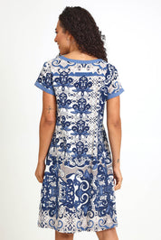 Model Pamelar wearing size 10 of the Patch Dress – Print in colour Print, from the back