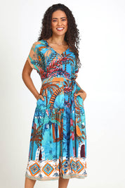 Model Pamelar wearing size 10 of the V-Neck Button Through Dress – Print in colour Print, from the front