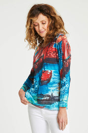 Model Emma wearing size 10 of the Organic Cotton Crew LS Tee in colour Venicemult (Blue), from the front, cropped image