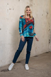 A model wearing the Organic Cotton Crew LS Tee in colour Venicemult (Blue), from the front, showing the whole outfit