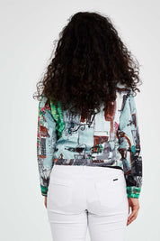 A model wearing size 10 of the Tuscany Cotton Biker Jacket in colour Print (Blue), from the back