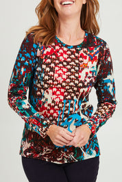 Model Katie wearing size 10 of the Ikat Crew LS Tee in colour Ikat (Red), from the front, cropped image
