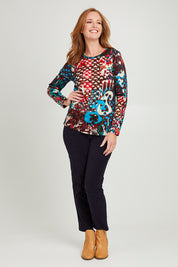 Model Katie wearing size 10 of the Ikat Crew LS Tee in colour Ikat (Red), from the front, showing the whole outfit