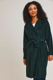 Model Ziara wearing size 10 of the Essentials Cotton Corduroy Trench Coat in colour Pine (Green), from the front, cropped image
