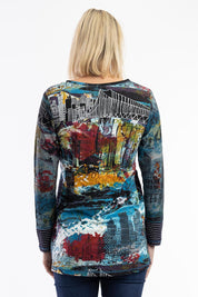 A model wearing the New York Patch Tunic Top in colour Newyork (Blue), from the back