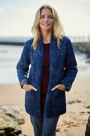 Model Maggie wearing size 10 of the Dancing Queen Reversible Cotton Coat in colour Dancing (Blue), from the front, showing the whole outfit