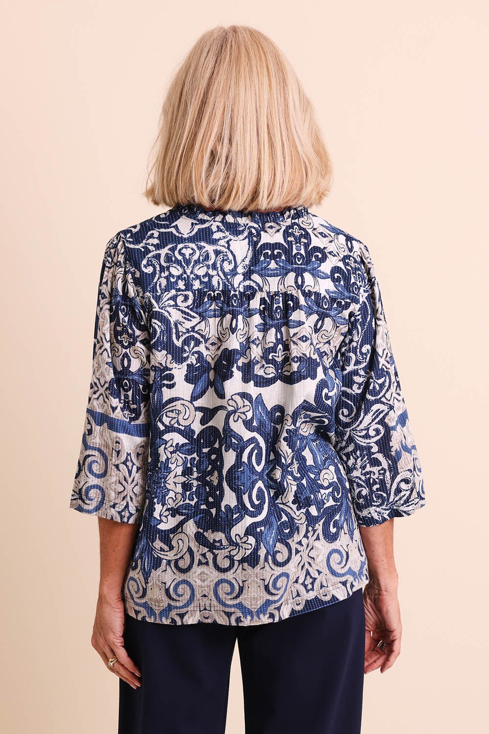Model Sandys wearing size 10 of the Frill Neckline Cotton Top – Print in colour Print, from the back
