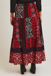 Model Ziara wearing size 10 of the Jolene Cord Skirt in colour Jolene (Red), from the back