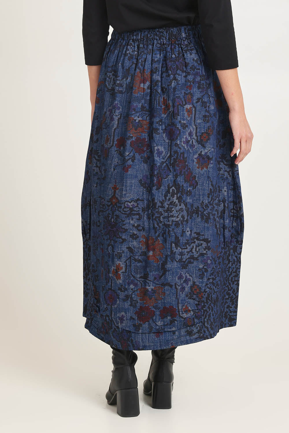 Model Madeline wearing size 10 of the Tabriz Skirt in colour Tabriz (Blue), from the back