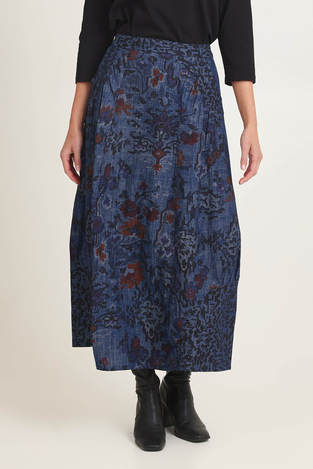 Model Madeline wearing size 10 of the Tabriz Skirt in colour Tabriz (Blue), from the front, cropped image