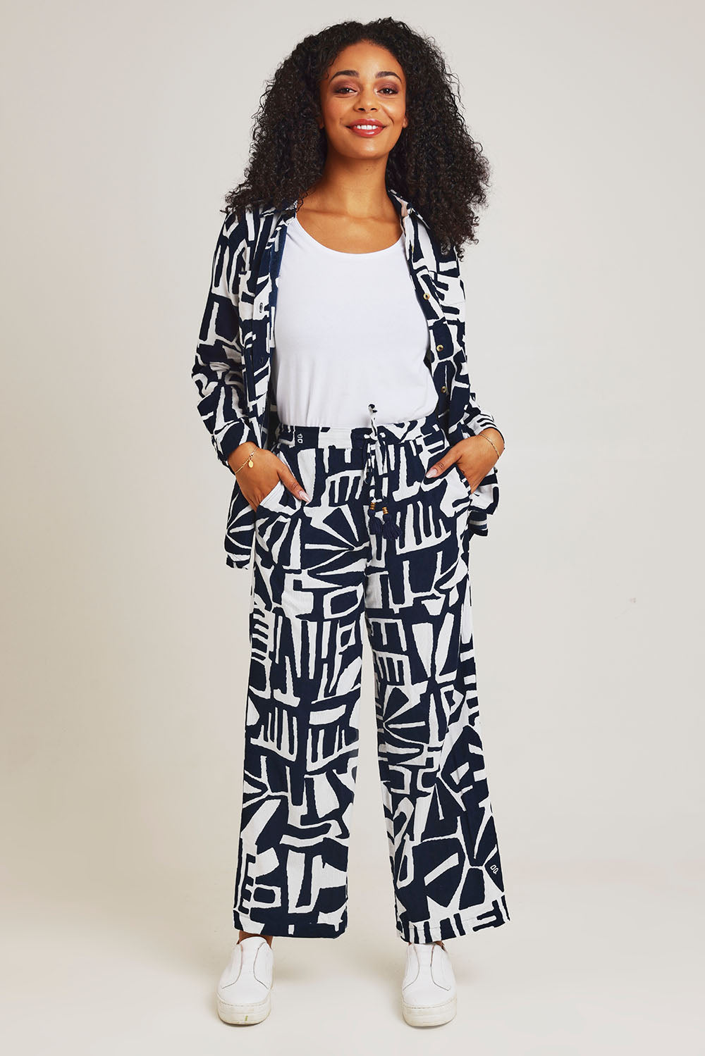 Model Ziara wearing size 10 of the Corduroy Flared Trouser in colour Navy (Blue), from the front, showing the whole outfit