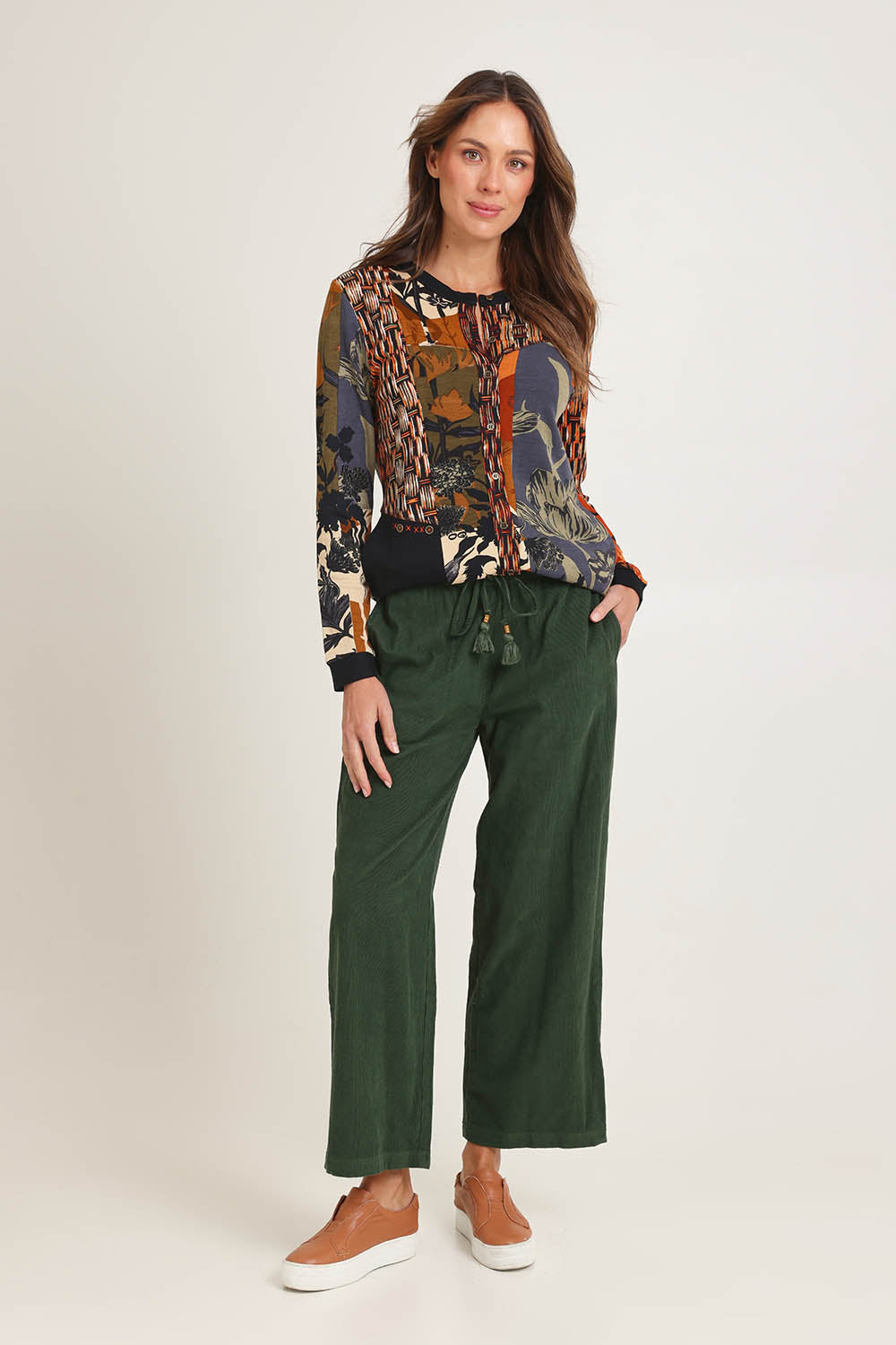 Model Madeline wearing size 10 of the Cord Solids Wide Leg Pant in colour Military (Green), from the front, showing the whole outfit