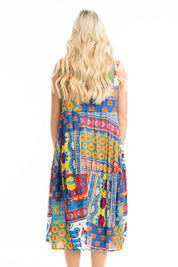 A model wearing the Amritsar Organic Cotton Bubble Sleeveless Dress in colour Print (Blue), from the back