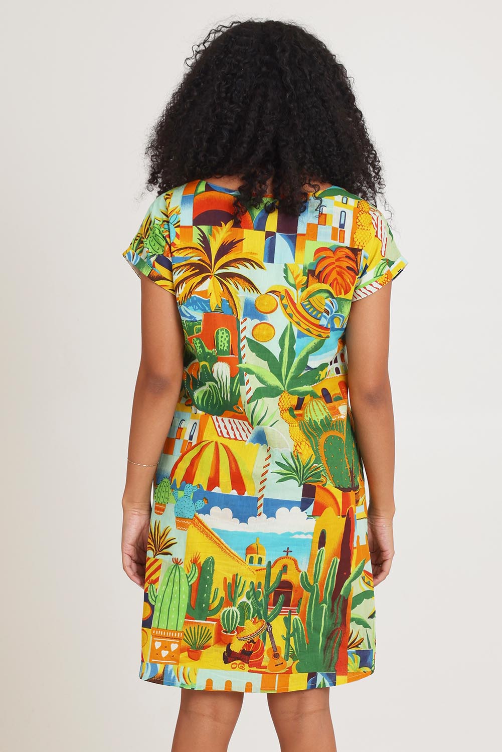 Model Ziara wearing size 10 of the Short Sleeve Reversible Cotton Dress in colour Guatemala, from the back