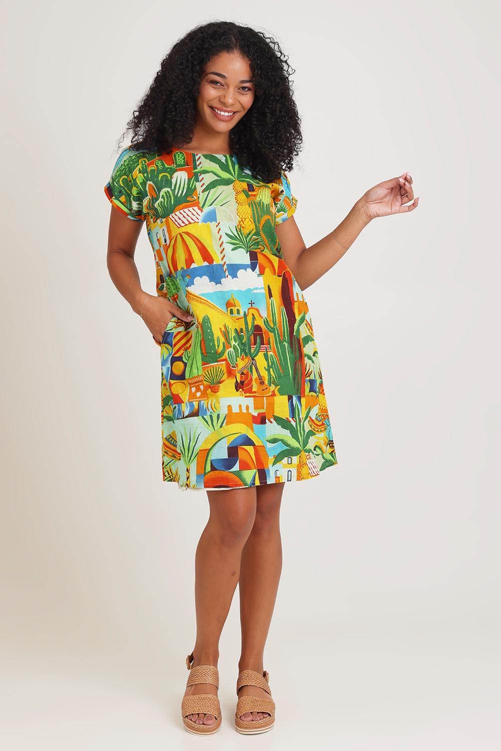Model Ziara wearing size 10 of the Short Sleeve Reversible Cotton Dress in colour Guatemala, from the front, showing the whole outfit