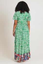Model Ziara wearing size 10 of the Tie Waist Dress in colour Buzios (Green), from the back