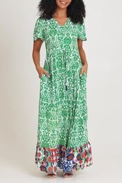 Model Ziara wearing size 10 of the Tie Waist Dress in colour Buzios (Green), from the front, cropped image