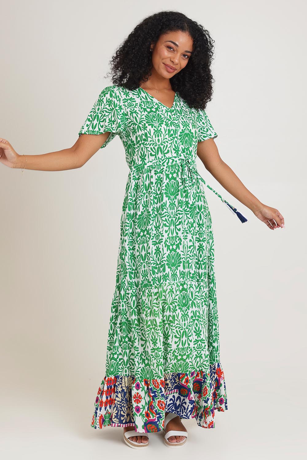 Model Ziara wearing size 10 of the Tie Waist Dress in colour Buzios (Green), from the front, showing the whole outfit
