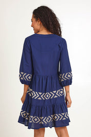 Model Pamelar wearing size 10 of the Essentials Embroidered Layers Cotton Dress - Navy in colour Navy, from an angle