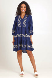 Model Pamelar wearing size 10 of the Essentials Embroidered Layers Cotton Dress - Navy in colour Navy, from the front